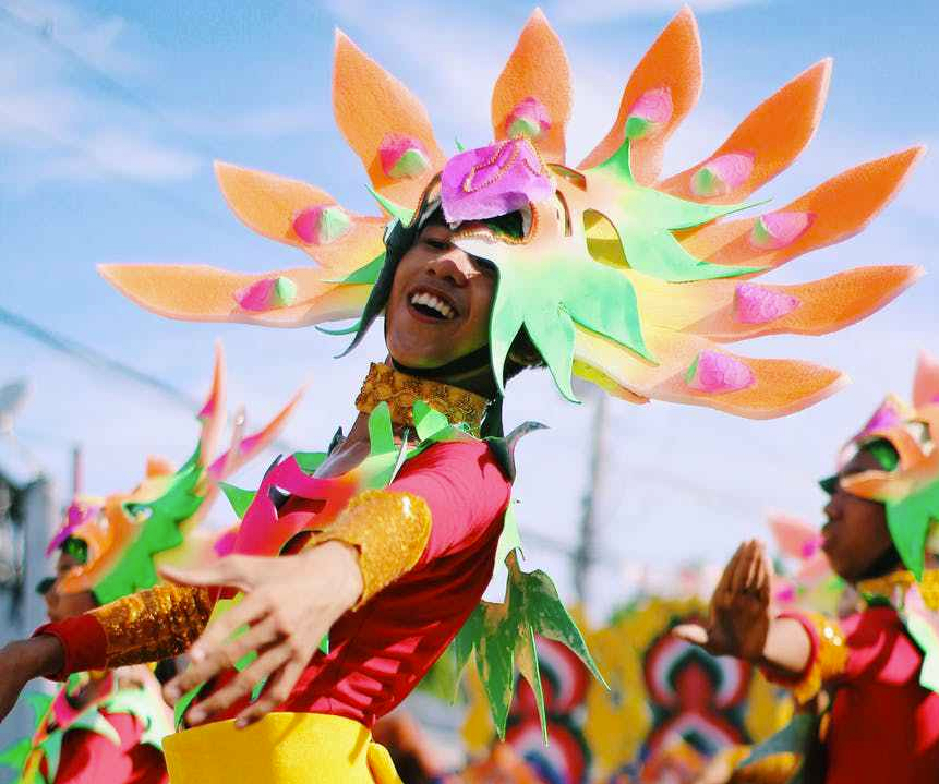 shallow focus photography of person wearing multicolored costume